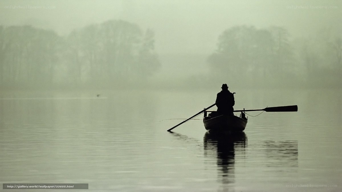Fisherman in a misty boat