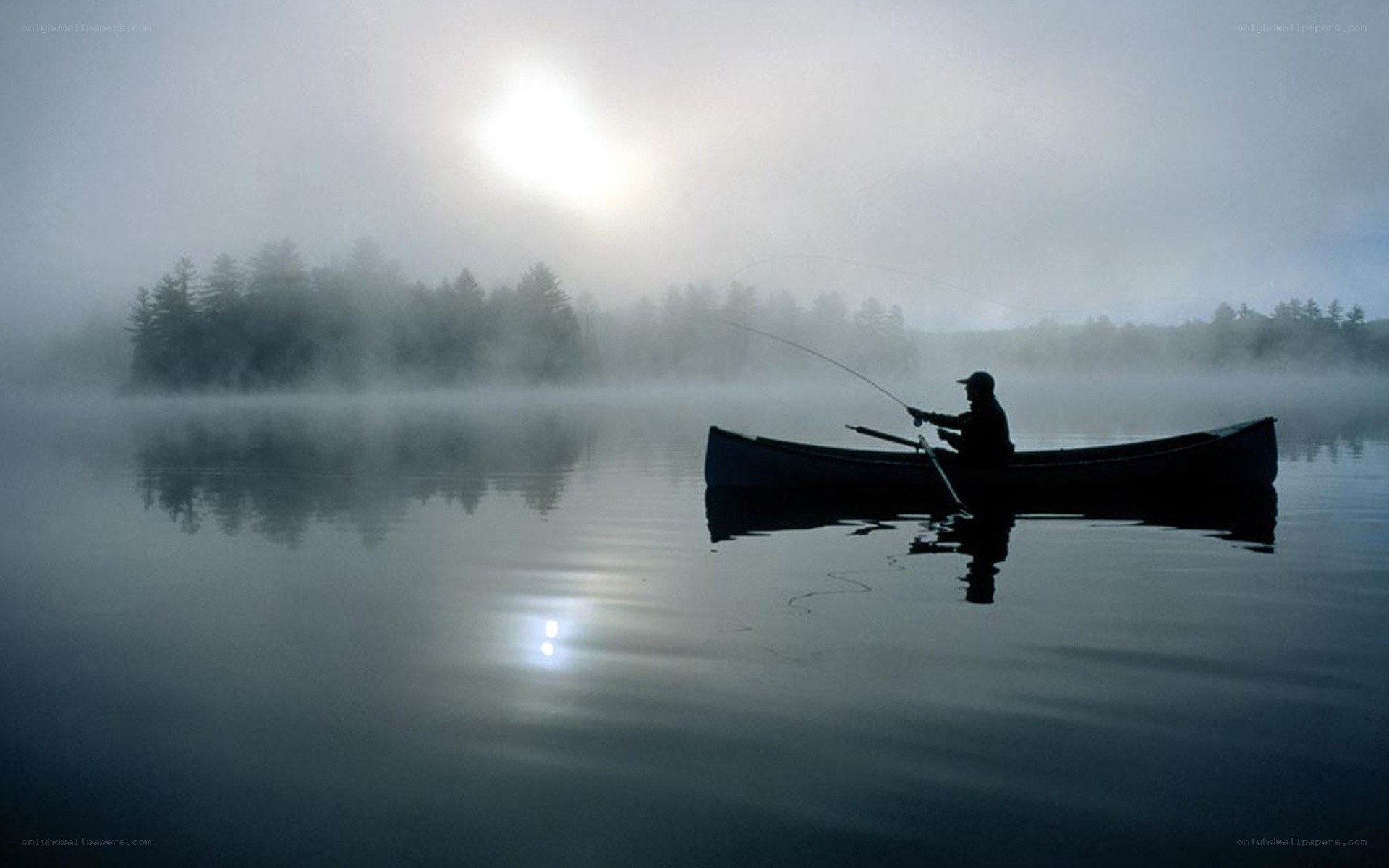 Fisherman in a misty canoe
