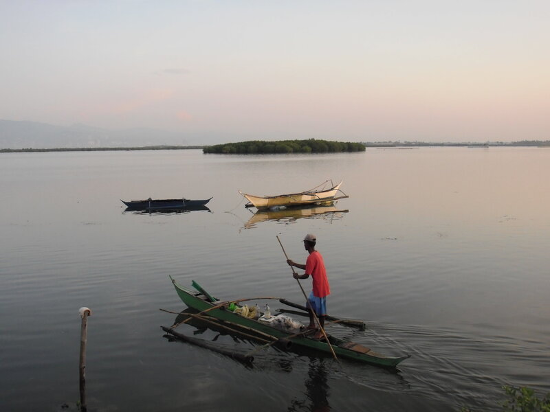 Fisherman on a boat at dusk