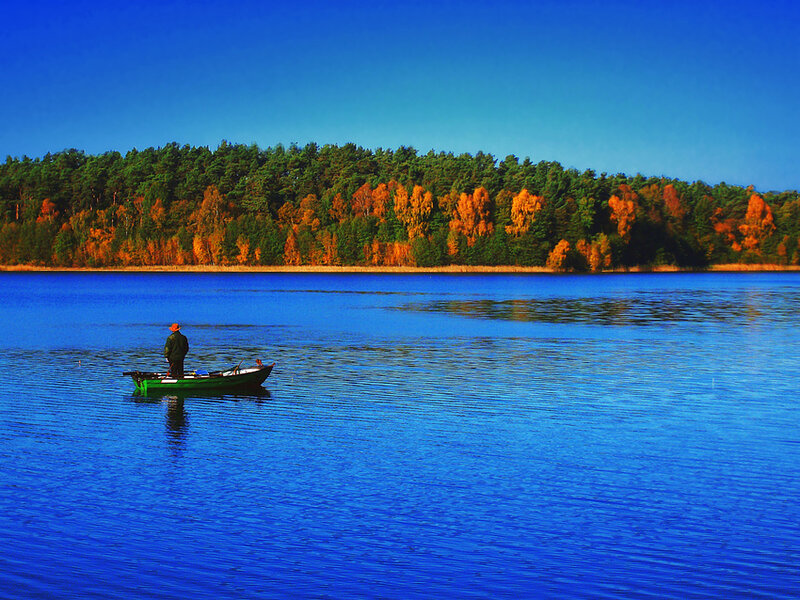 Fisherman on a lake in autumn