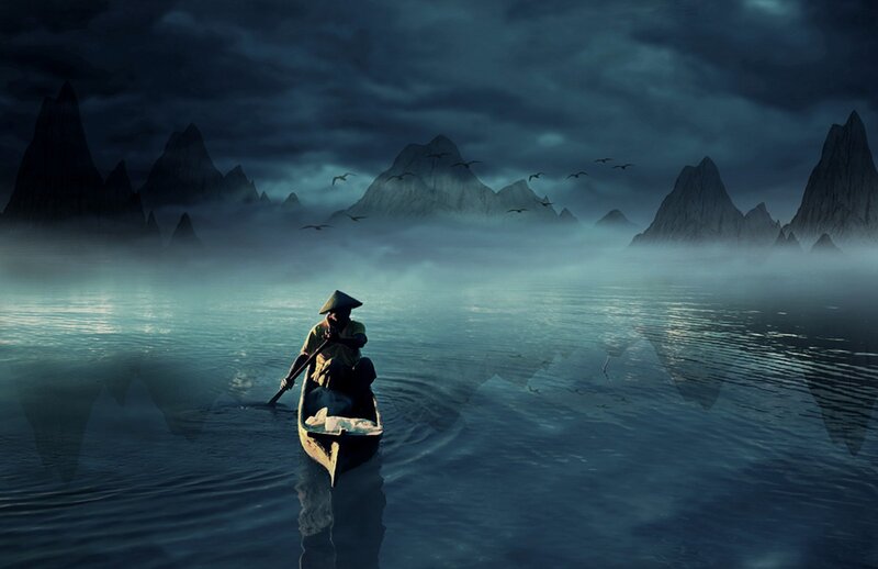 Fisherman on a misty lake