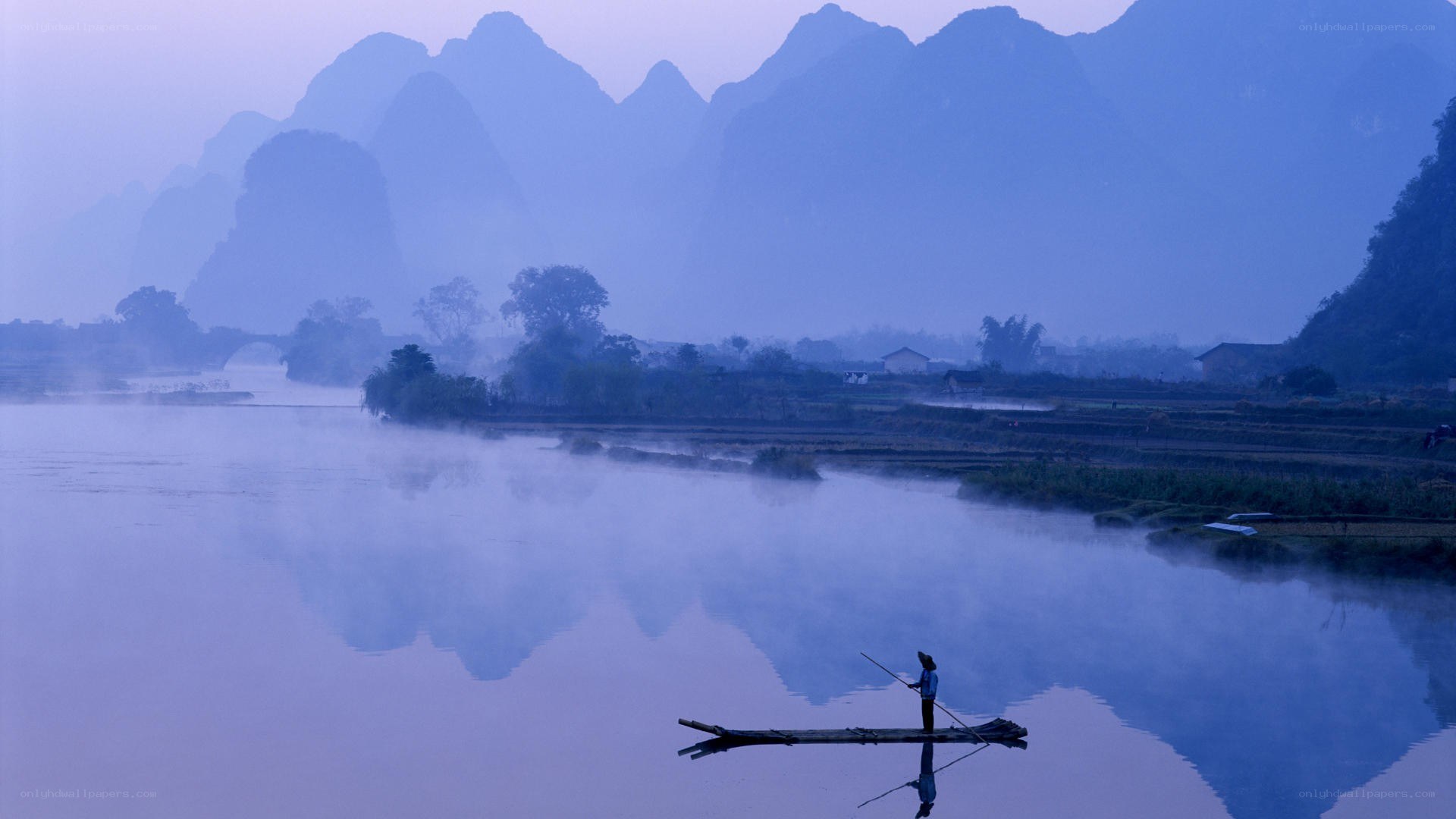 Fisherman on a misty river