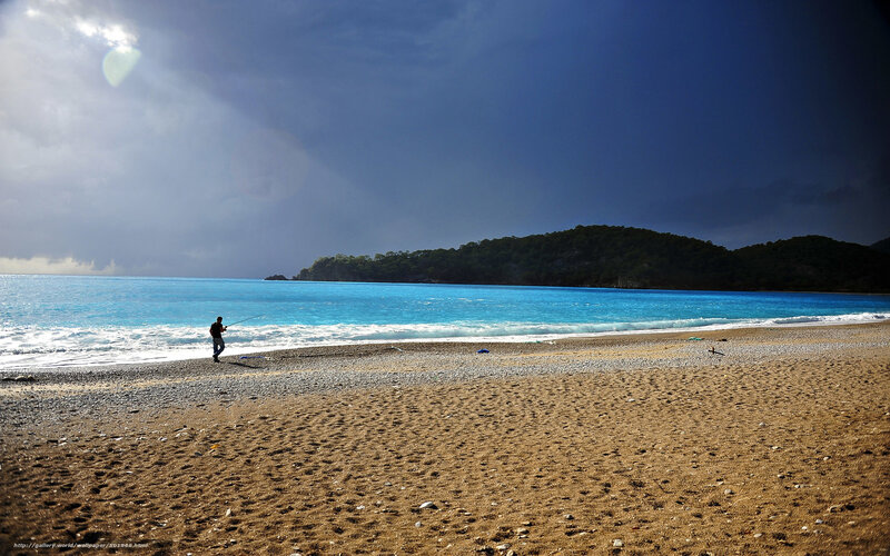 Fisherman on a pebble beach