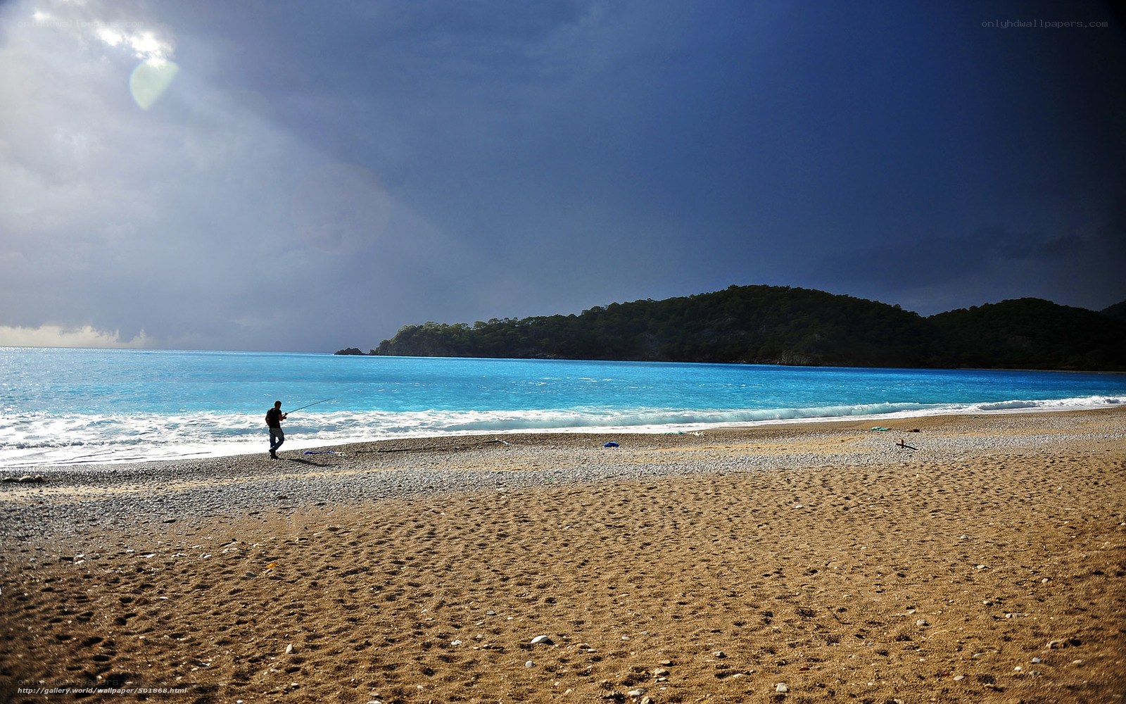 Fisherman on a pebble beach