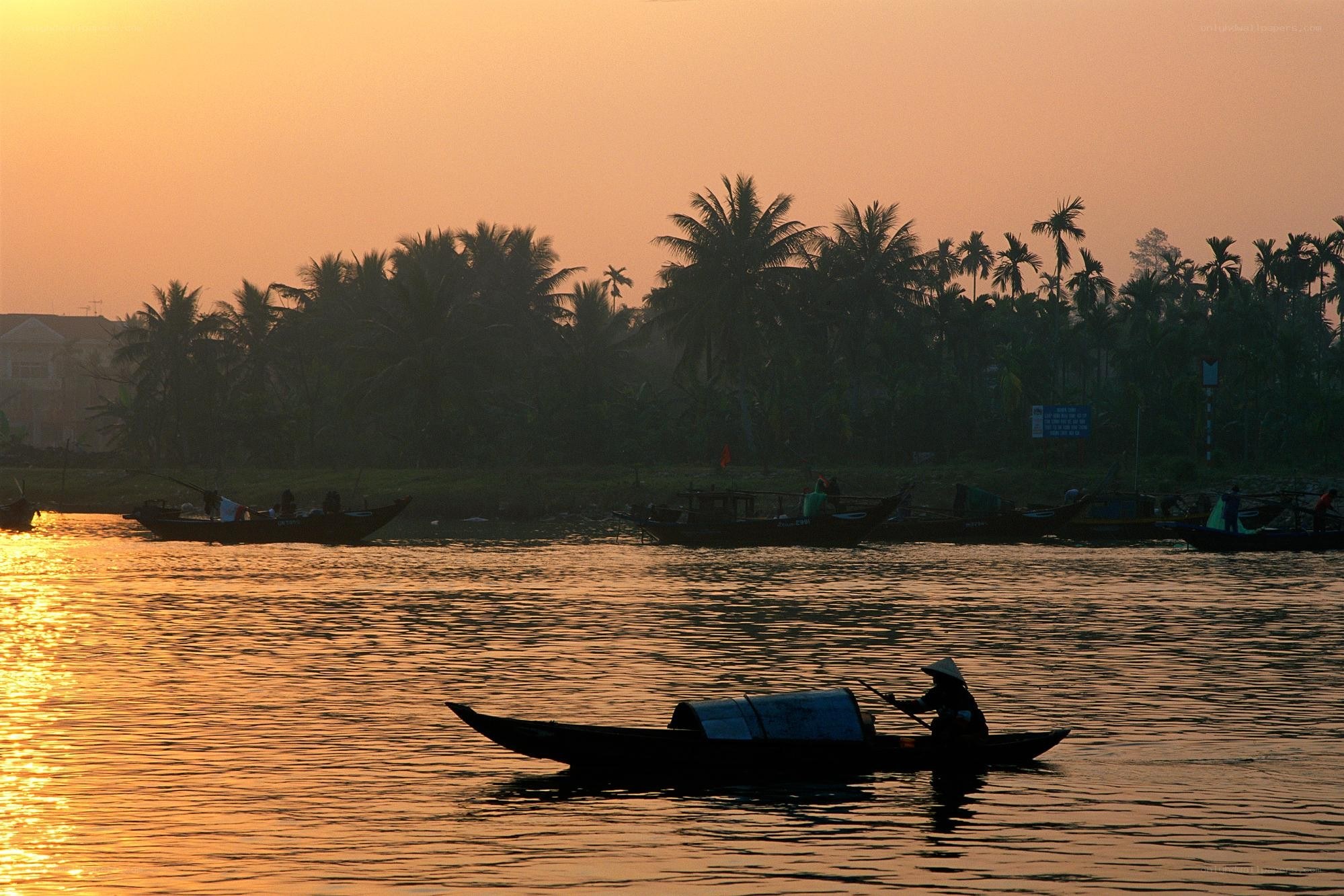 Fisherman on a river at sunset