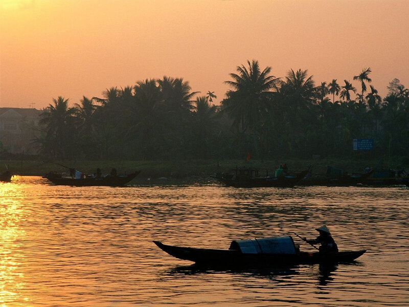 Fisherman on a river at sunset