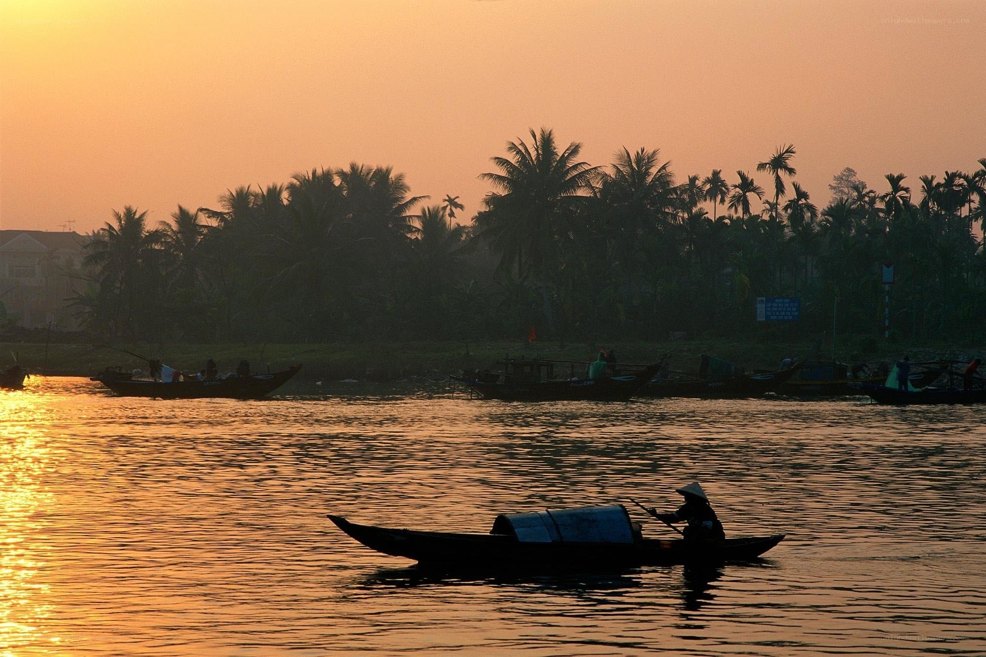 Fisherman on a river at sunset