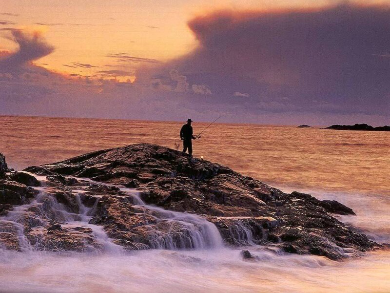 Fisherman on a rocky shore