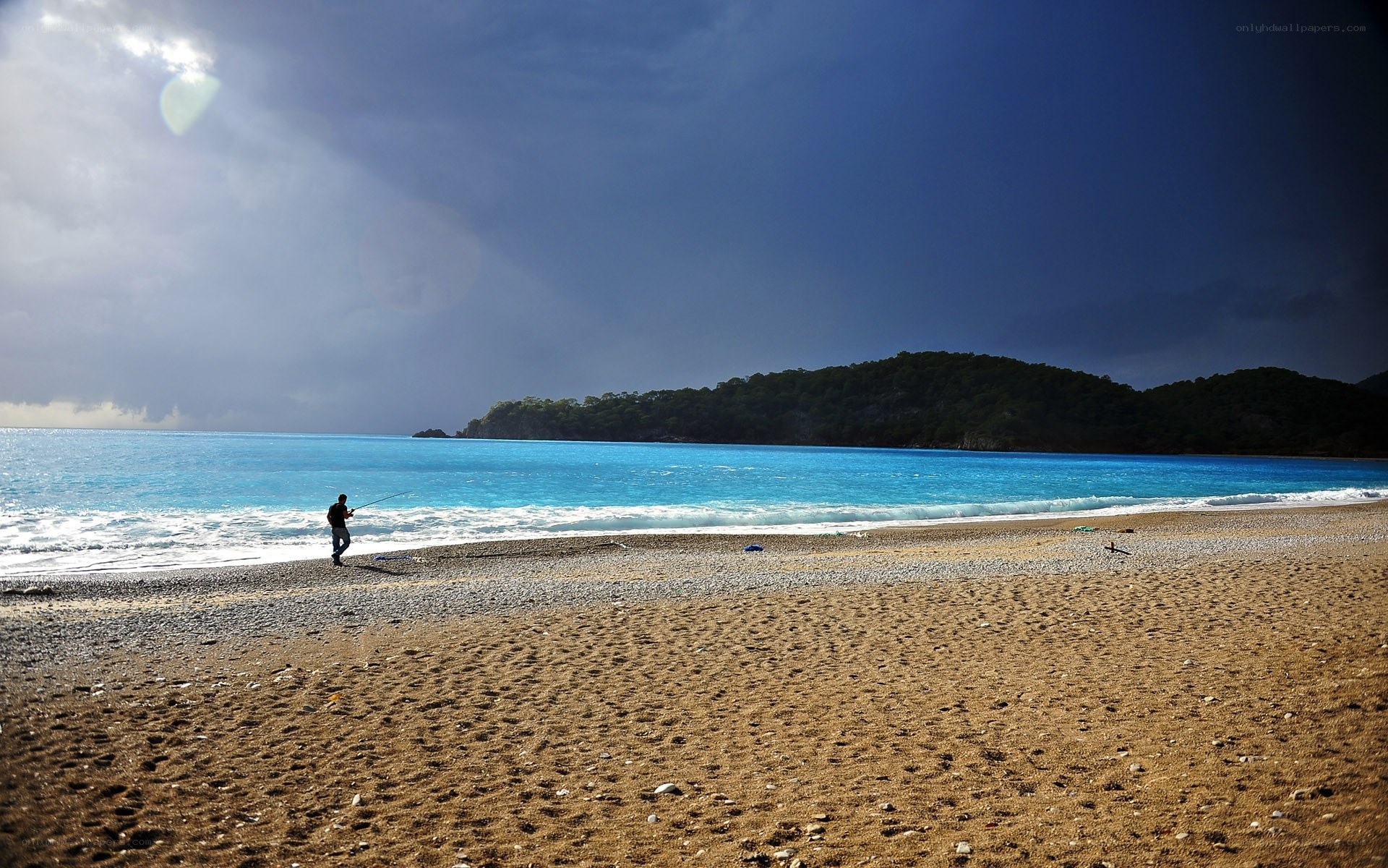 Fisherman on a stormy beach