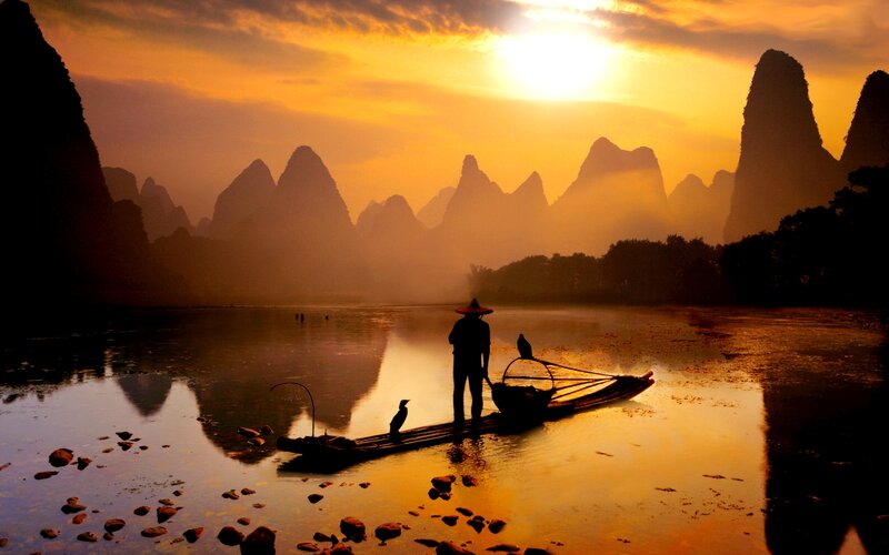 Fisherman on Bamboo Raft — Orange, Serene, Sunset