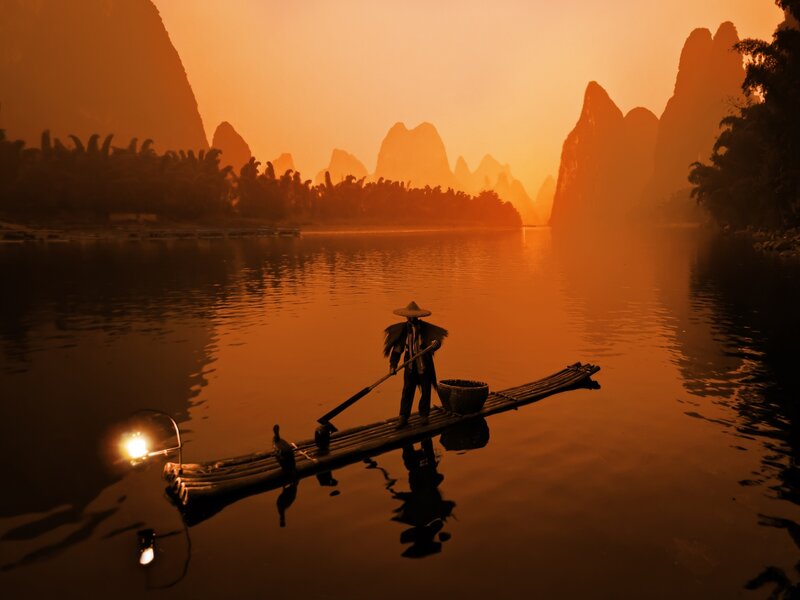Fisherman on Bamboo Raft — Orange, Serene