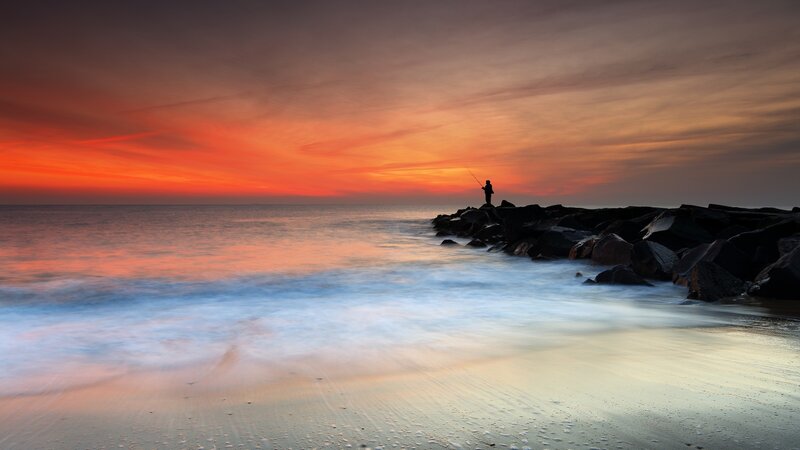 Fisherman on Jetty — Orange, Serene