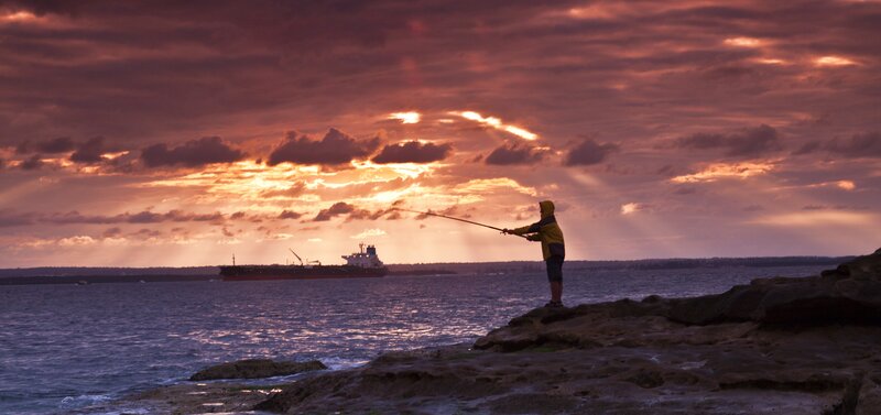 Fisherman on Rocks — Purple, Dramatic