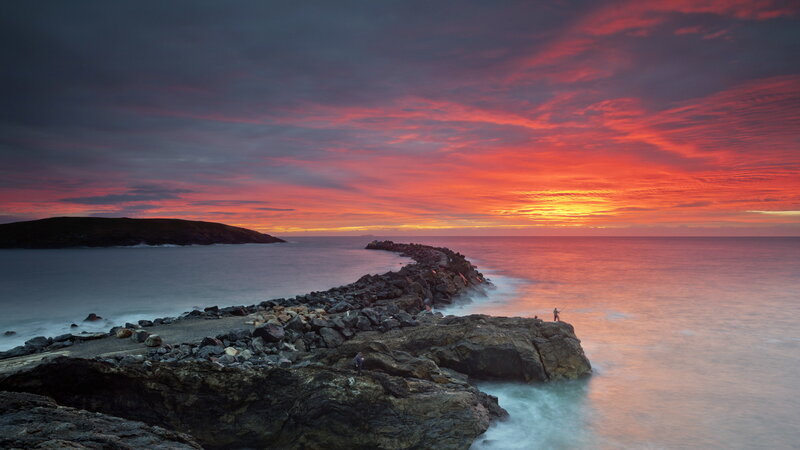 Fisherman on Rocky Pier — Red