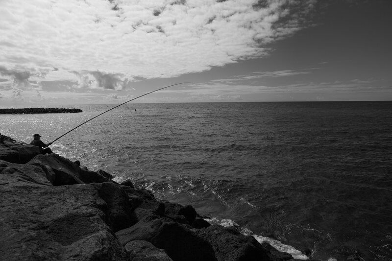 Fisherman on Rocky Shore — Black