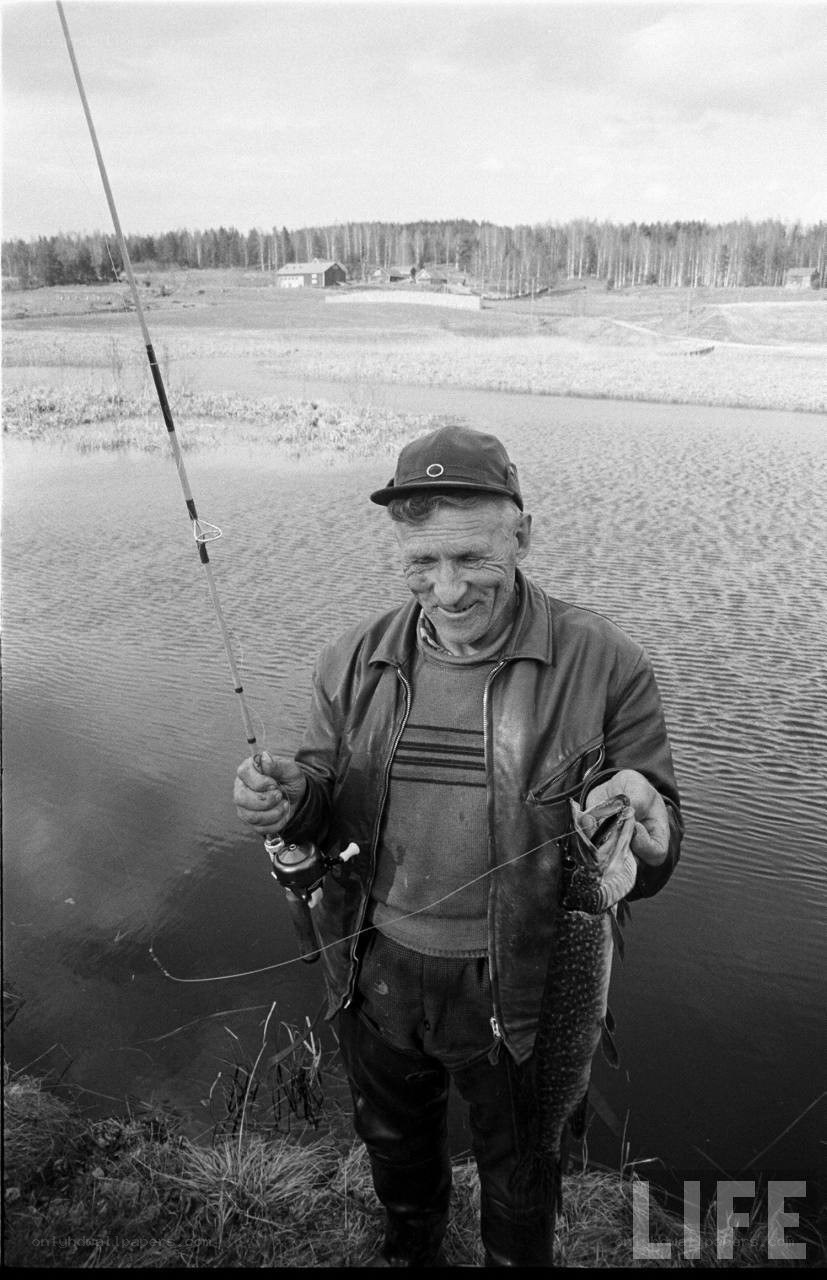 Fisherman with catch by lake