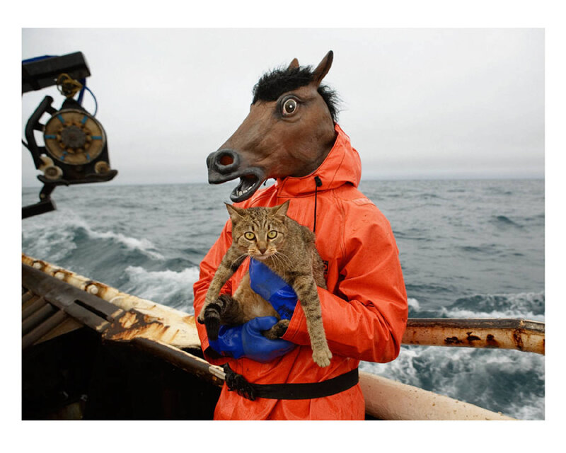 Fisherman with horse mask holding cat