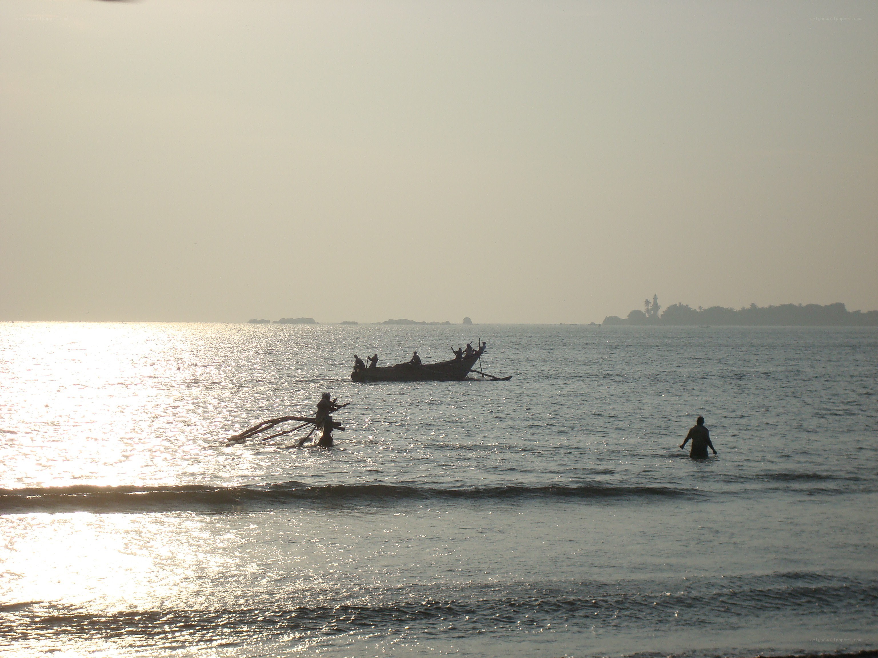 Fishermen at sunset on the water