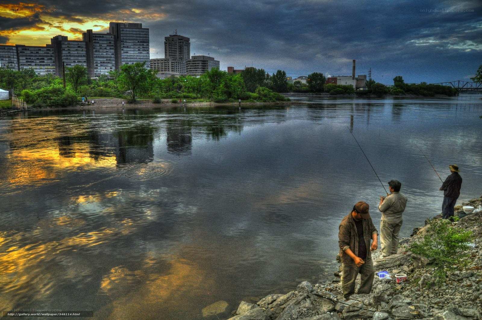 Fishermen by the river at dusk
