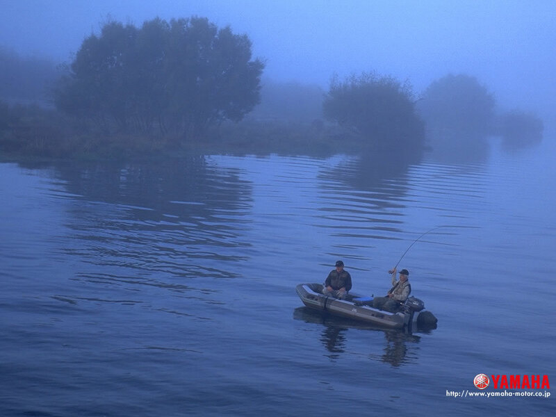 Fishermen on a foggy lake