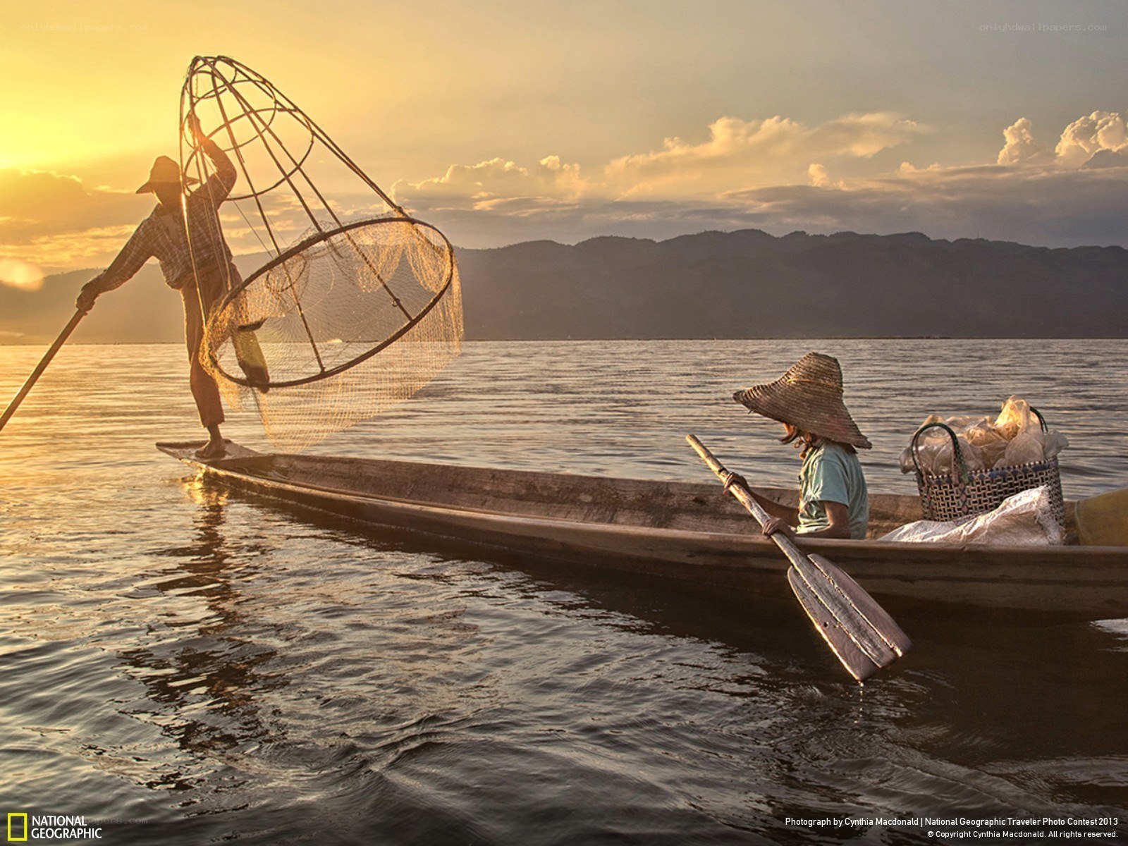 Fishermen on a lake at sunset