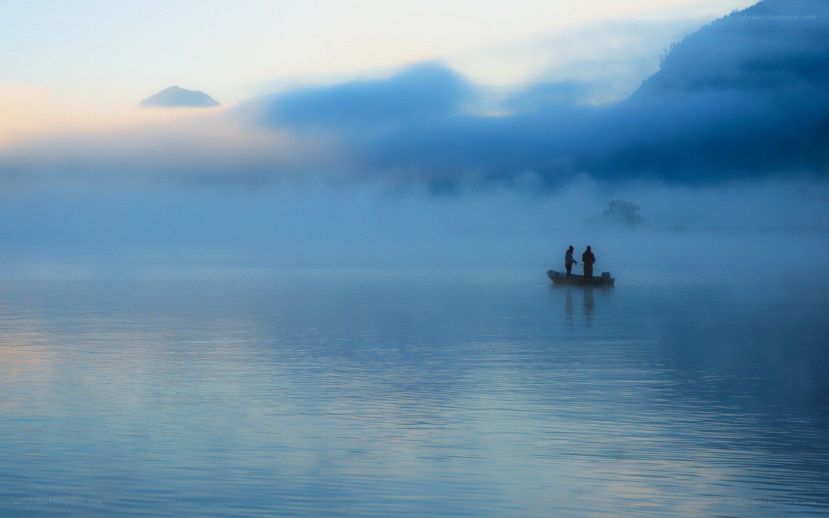Fishermen on a misty lake