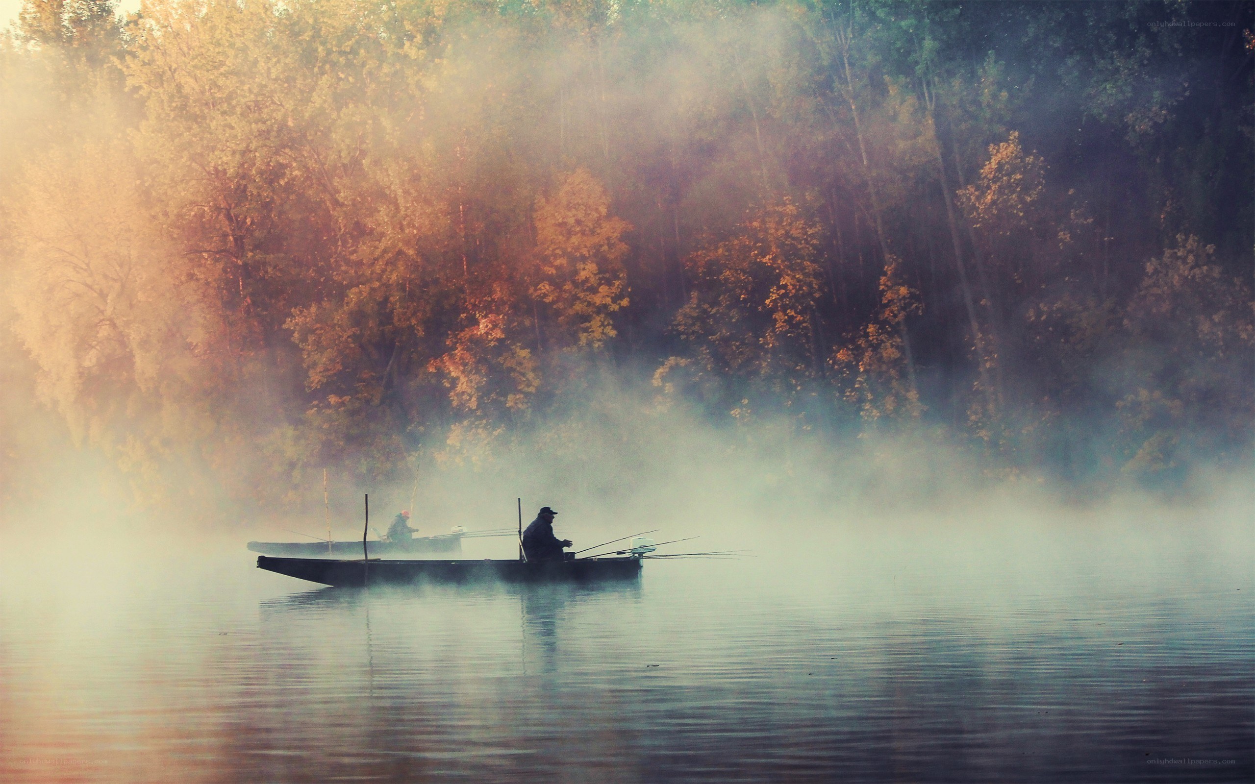 Fishermen on a misty lake