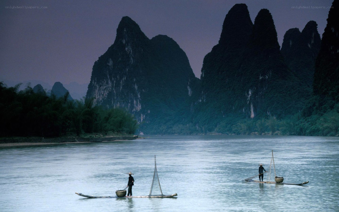 Fishermen on a river at dusk