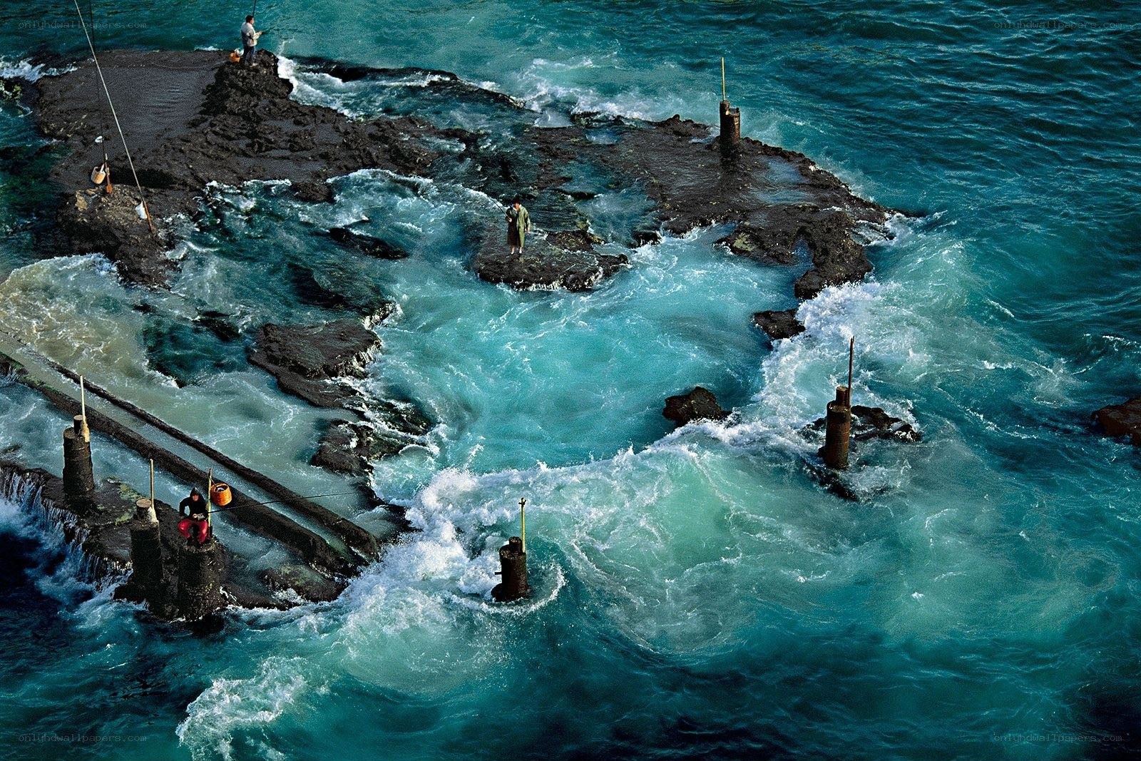 Fishermen on rocky pier