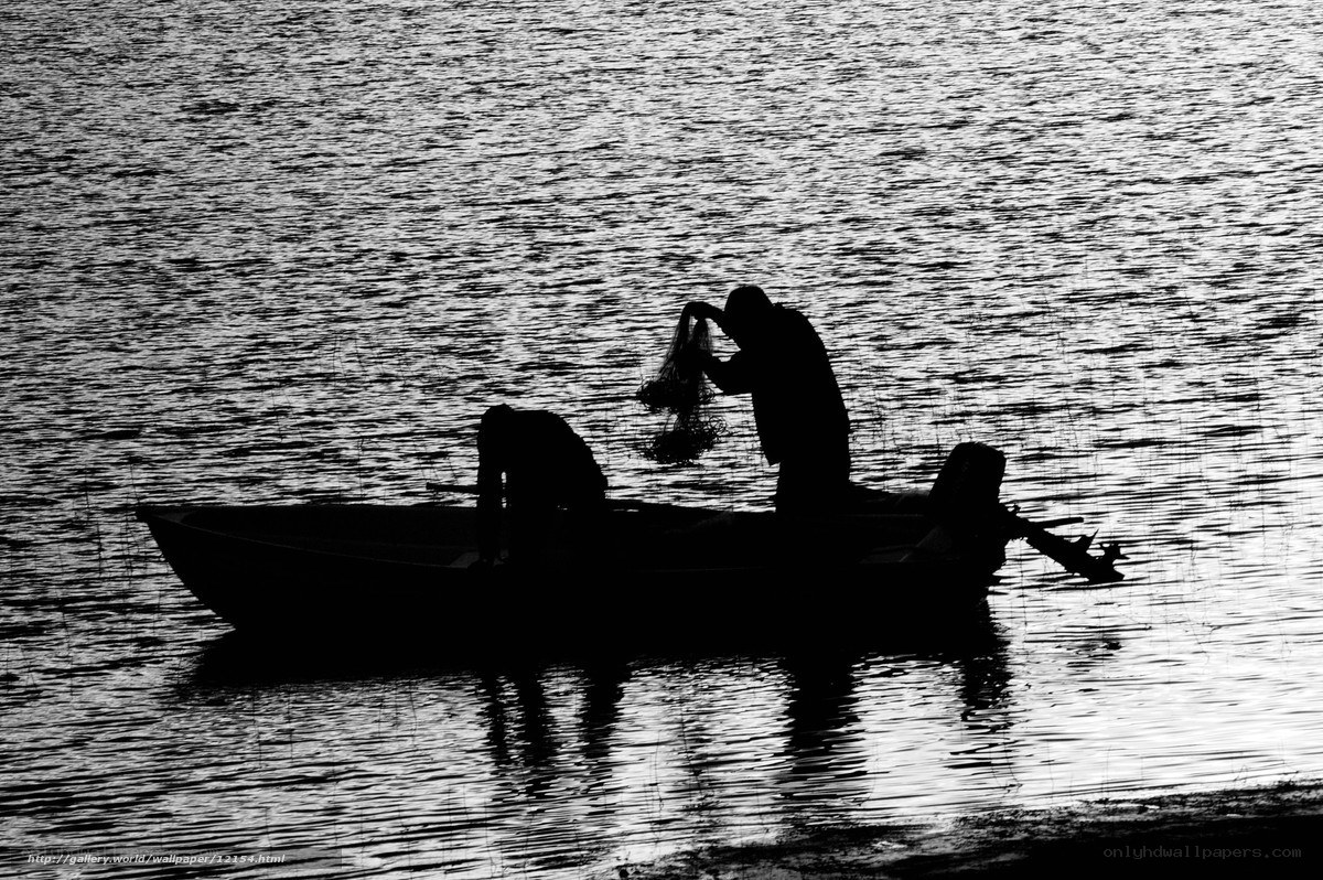 Fishermen silhouetted on a boat