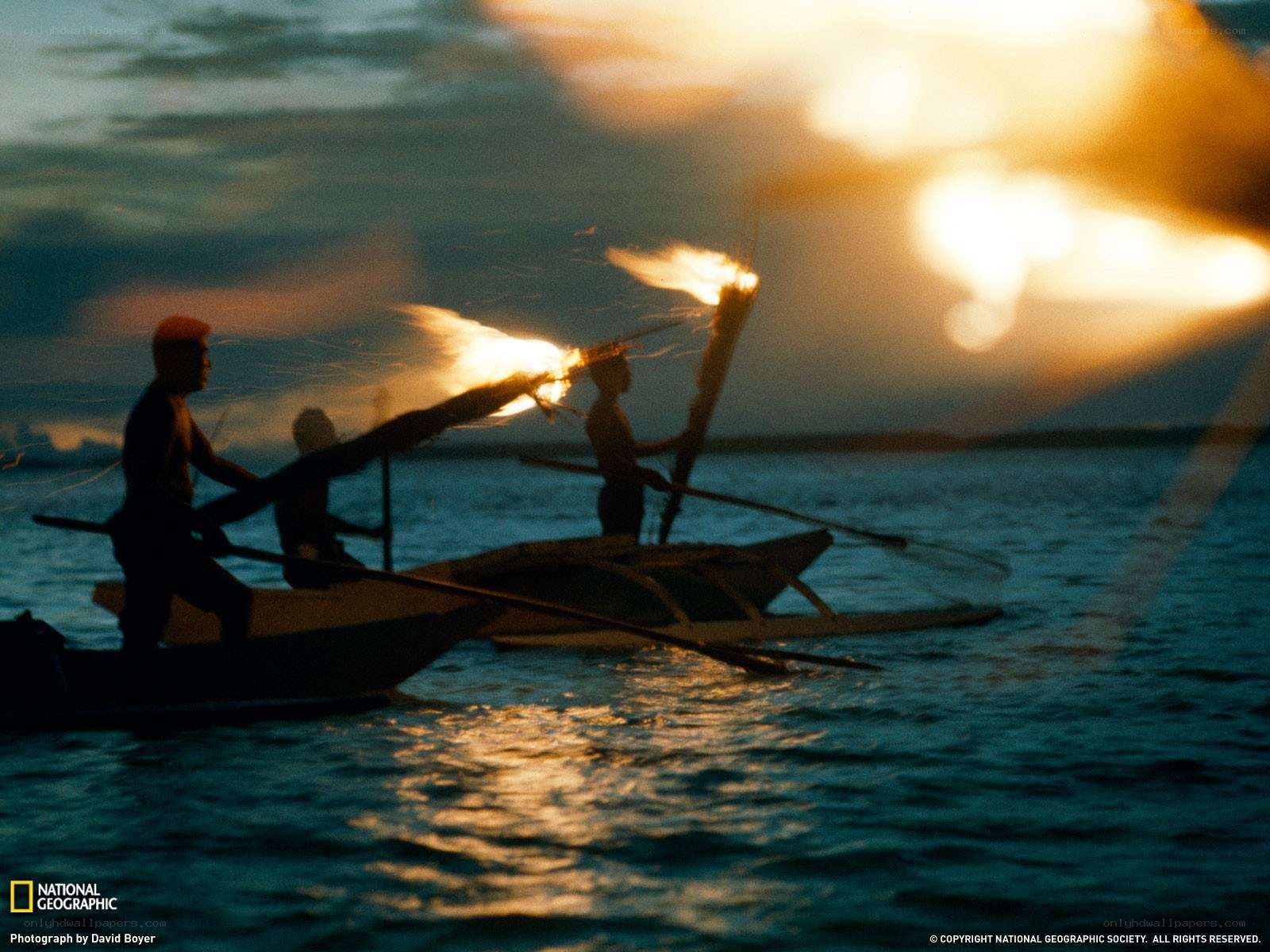 Fishermen using torches at dusk