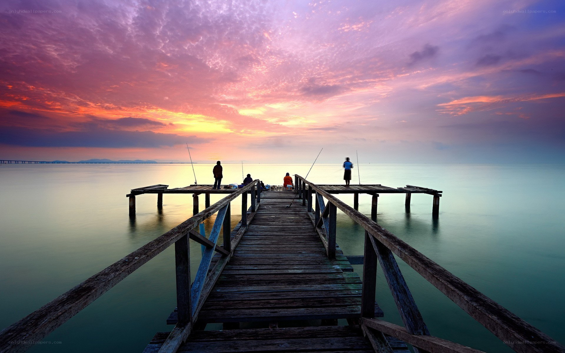 Fishing at sunset on a pier