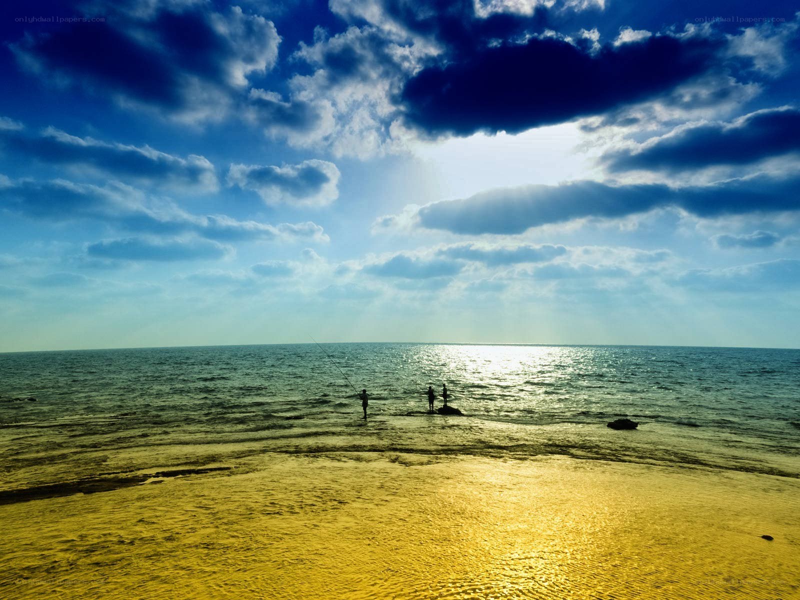 Fishing at the beach under a cloudy sky