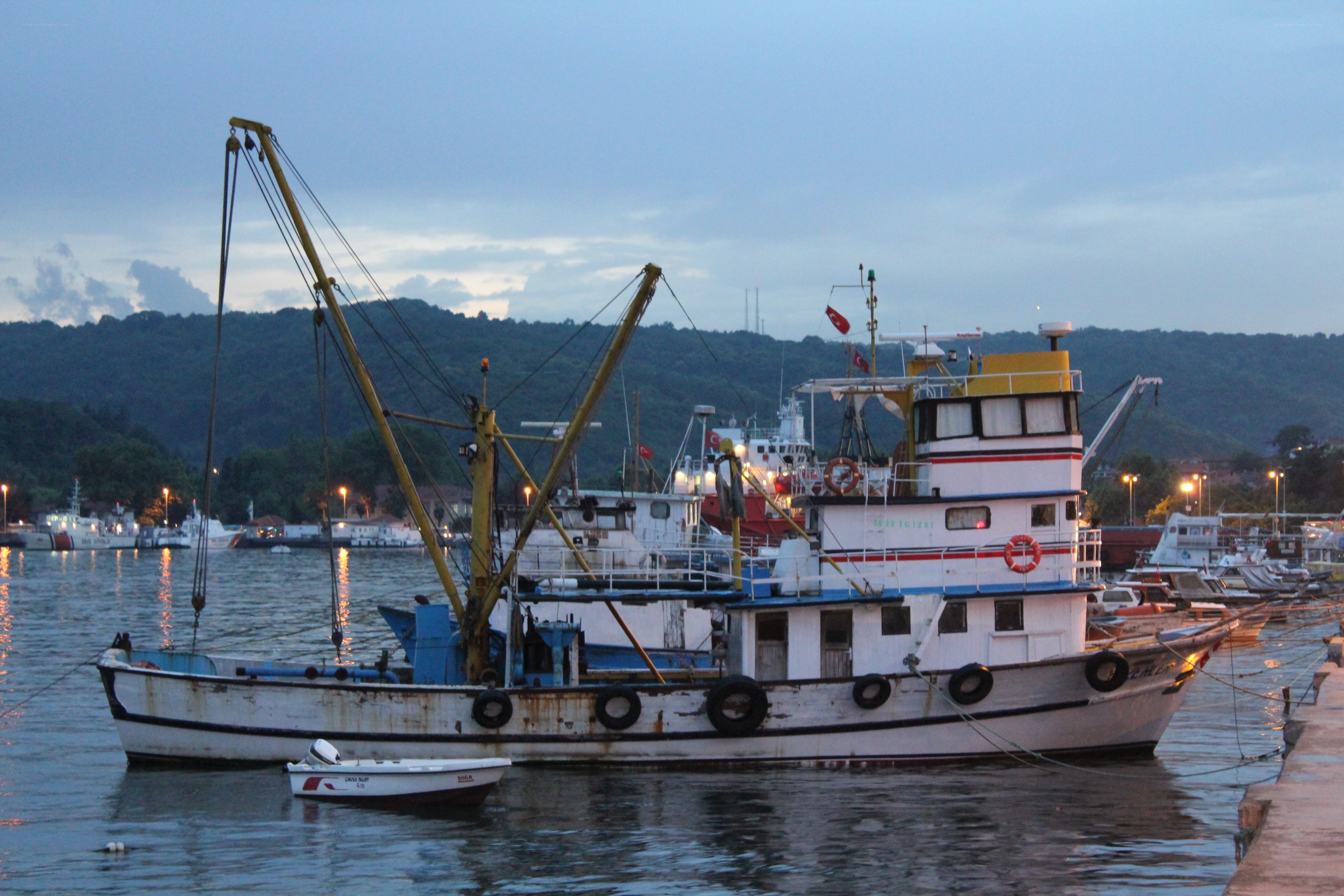 Fishing boat at dusk in harbor