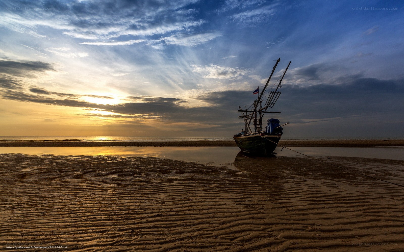 Fishing boat at sunset on beach