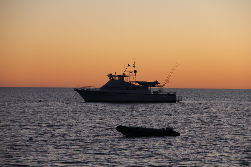 Fishing Boat at Sunset — Orange, Serene, Photograph, Inflatable Dinghy