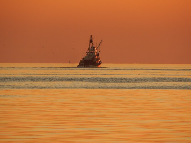 Fishing Boat at Sunset — Orange, Serene, Photograph, Sea