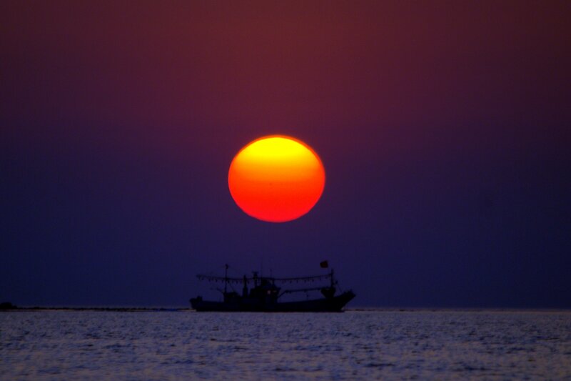 Fishing Boat at Sunset — Red, Dramatic, Photograph
