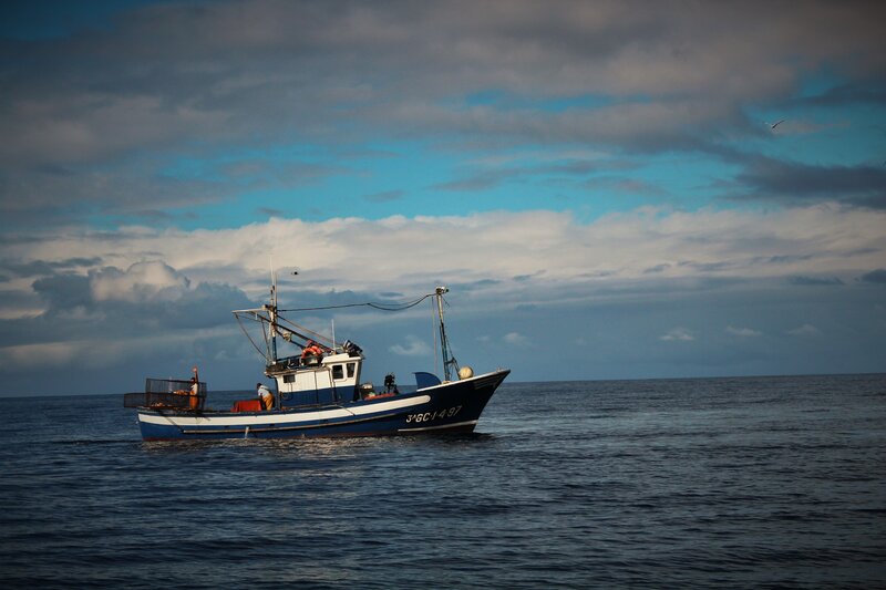 Fishing Boat on Ocean — Blue, Dramatic, Afternoon
