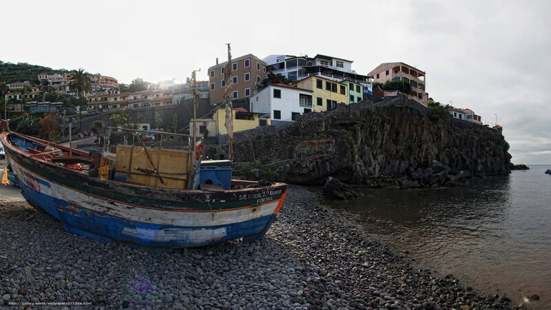 Fishing boat on pebble beach