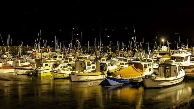 Fishing boats at night in a harbor