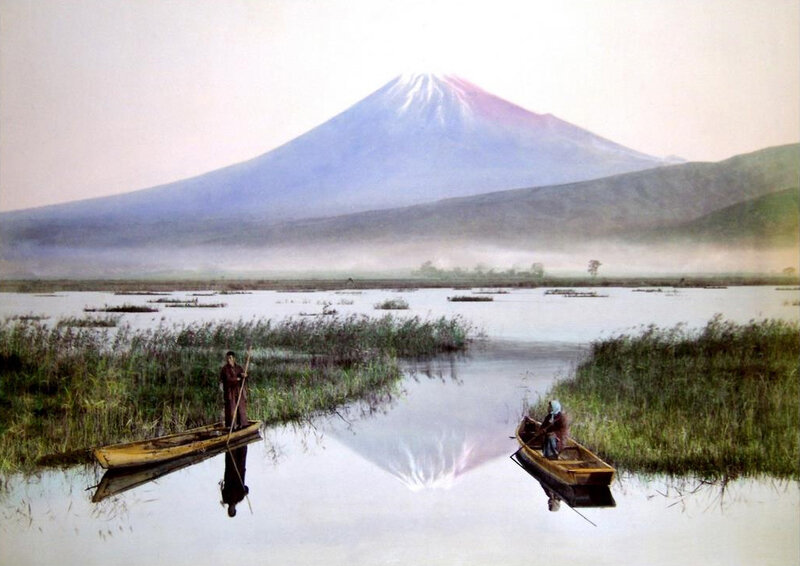 Fishing boats on a lake with Mount Fuji