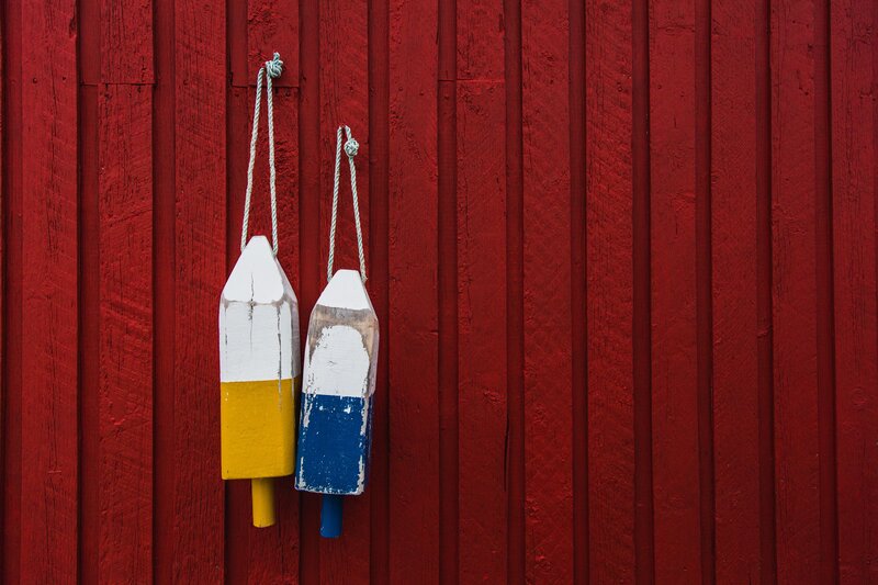 Fishing buoys on red wall