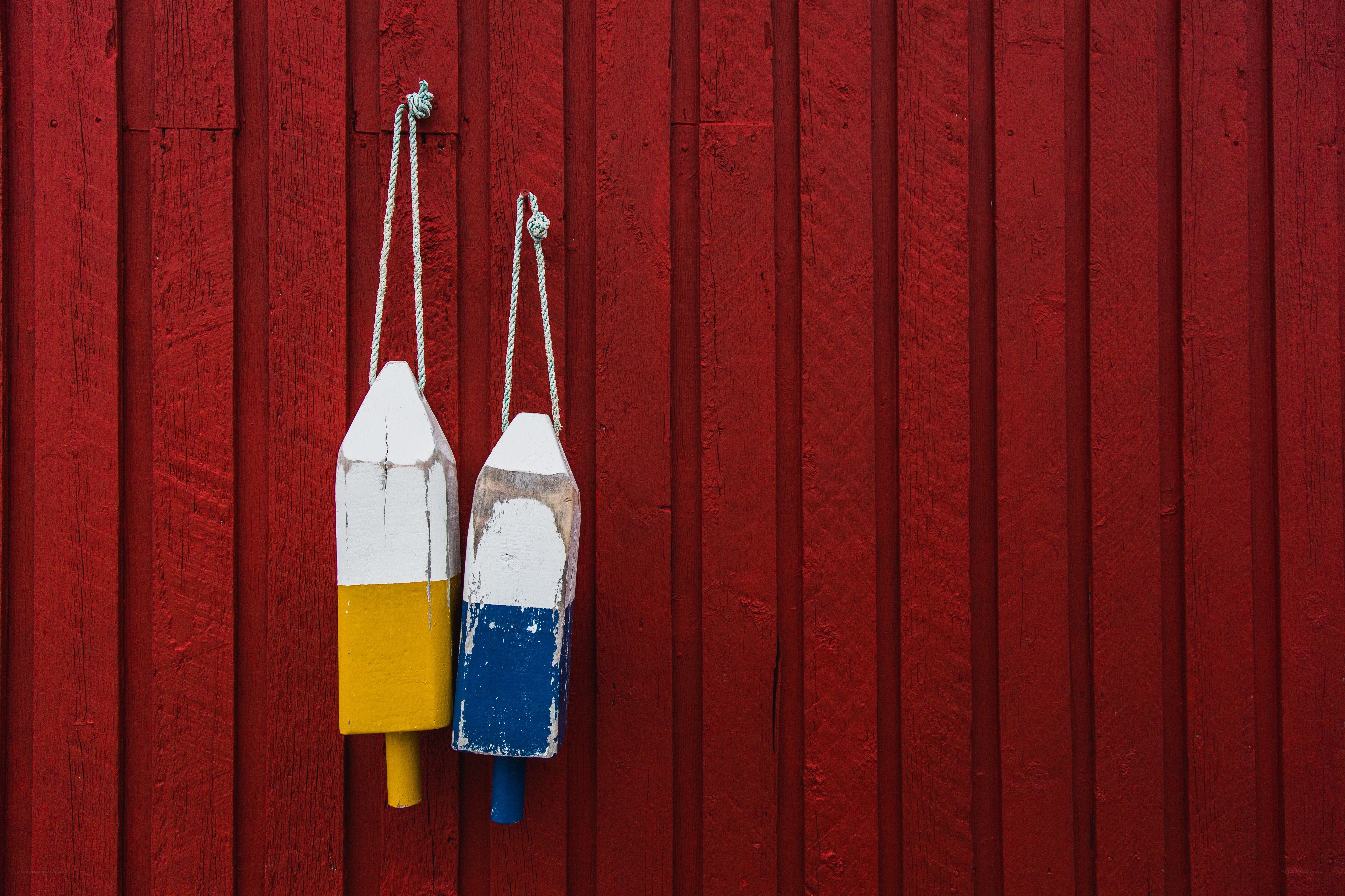 Fishing buoys on red wall