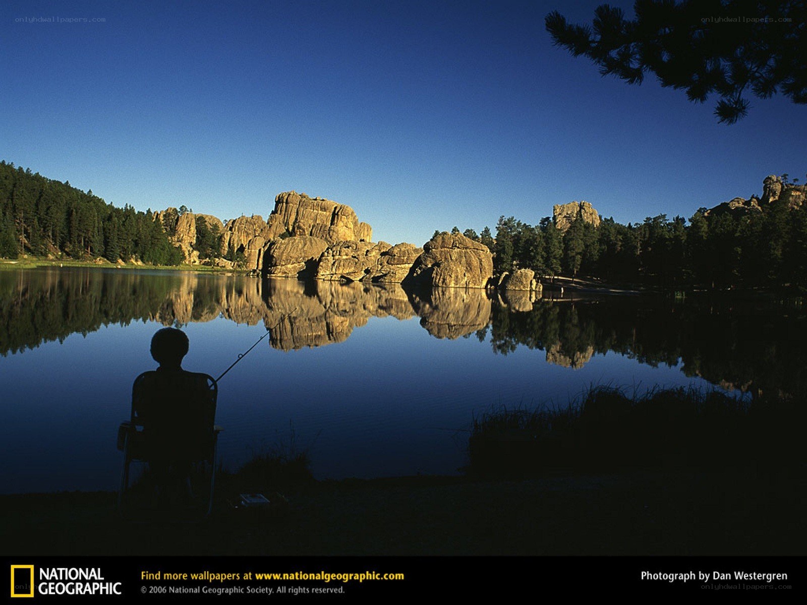 Fishing by a lake at sunrise