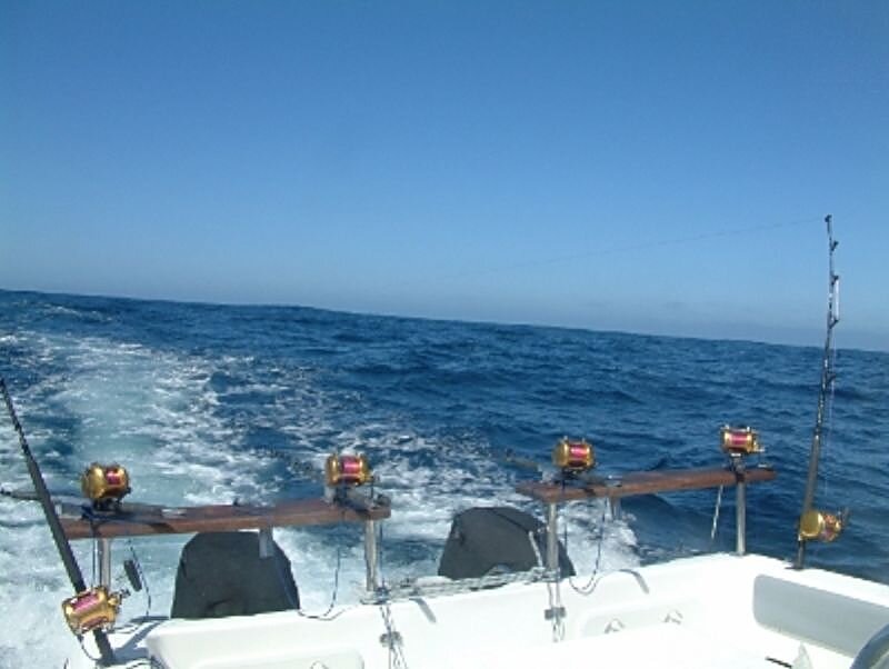 Fishing Rods on Boat — Blue, Calm