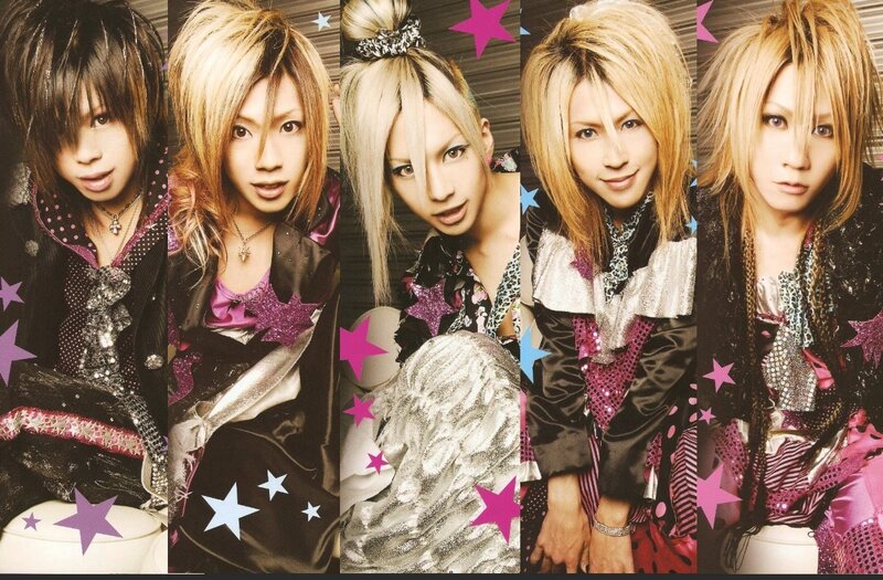 five band members in star-themed outfits