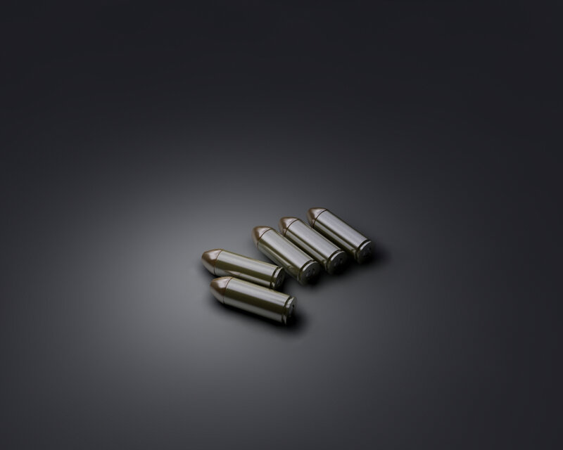 Five bullets on dark surface