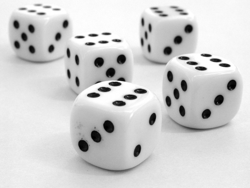 five dice on white surface