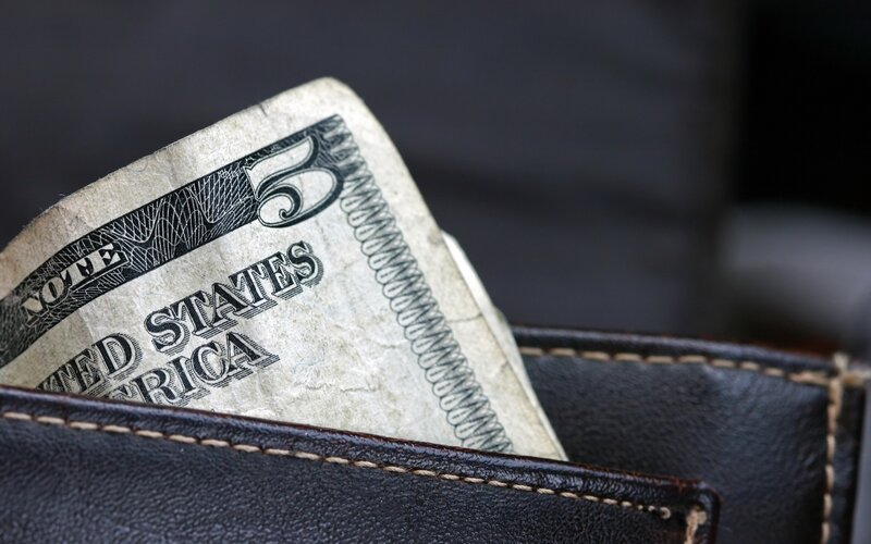 Five dollar bill in wallet